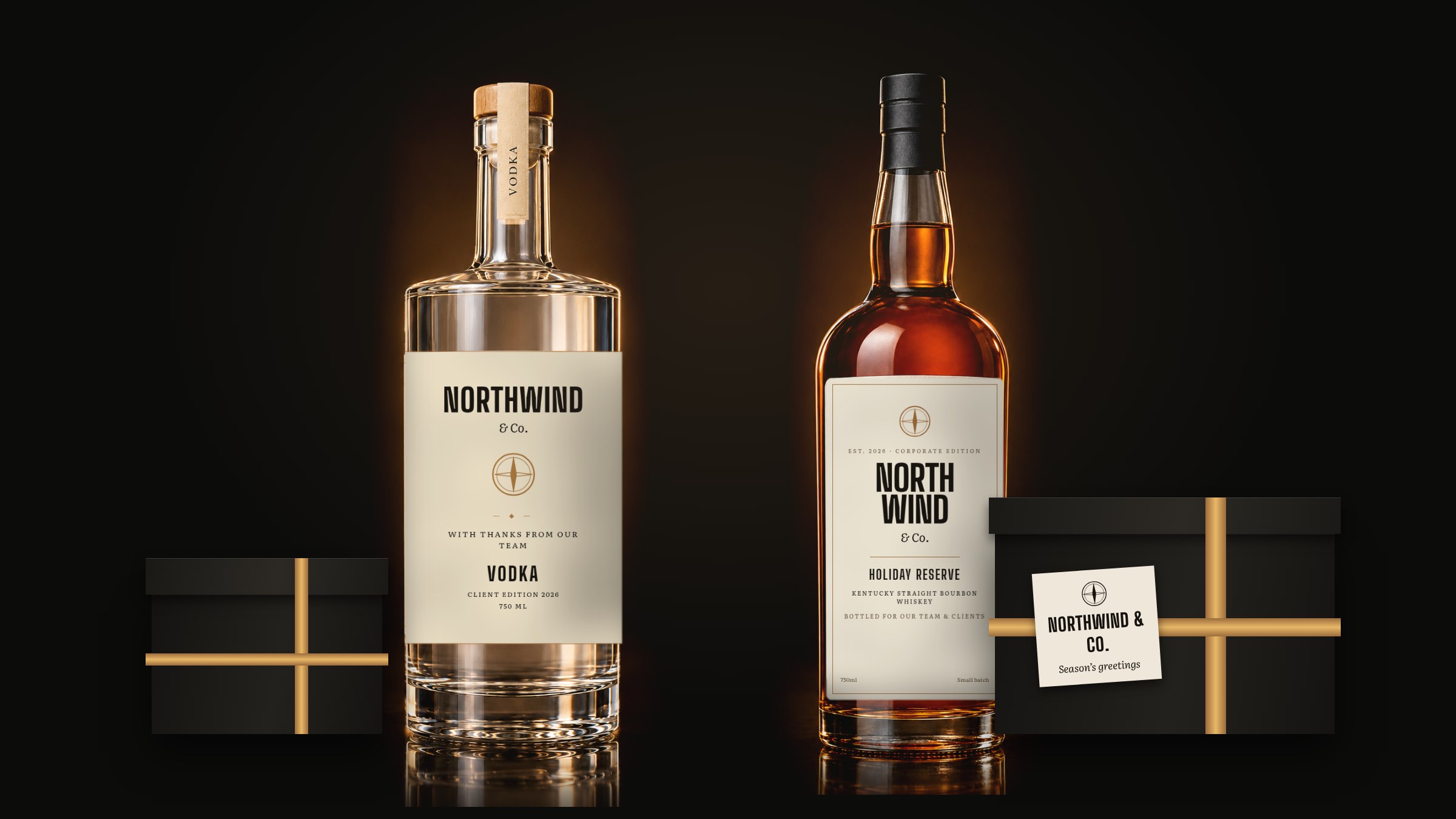A whiskey bottle with a custom label, black gift boxes with gold ribbon, and a greeting card.